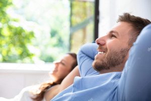 Man and Women Smiling on Couch After a Home Air Duct Inspection in Boca Raton, FL 