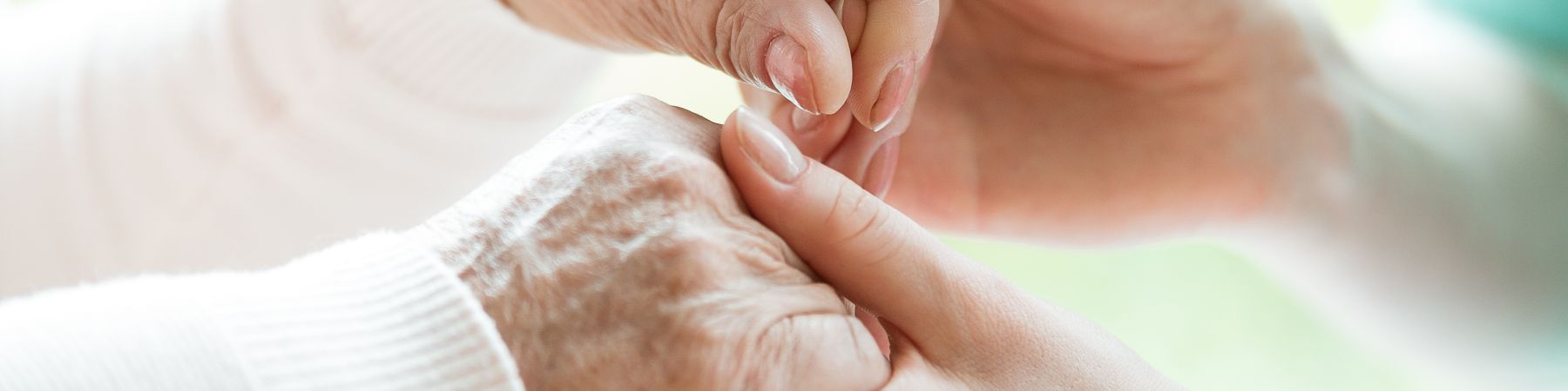 Closeup of the hands of a young woman holding hands of an elderly lady Air-Duct-Cleaning-Office-Disinfection-for-Assisted-Living-in-Fort-Lauderdale-FL-1