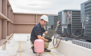 Man performing HVAC Maintenance in Fort Lauderdale, Deerfield Beach, Boynton Beach, and Nearby Cities