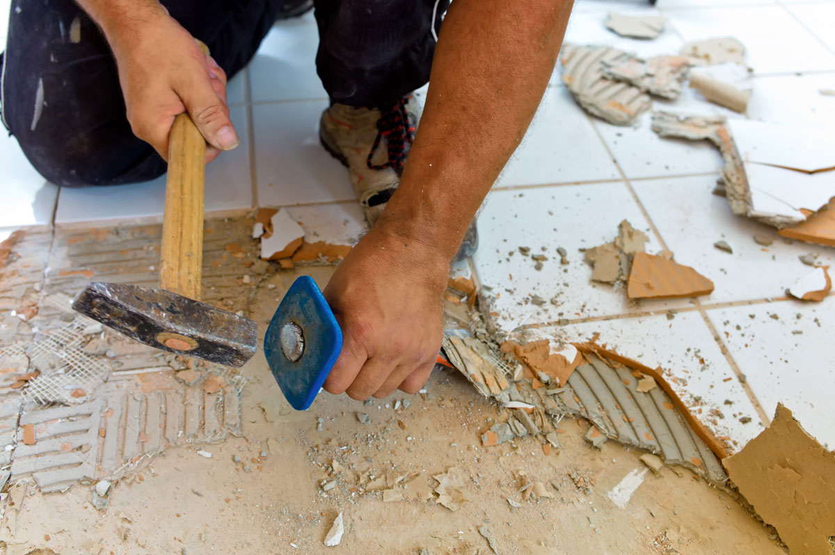 worker removing tile that requires Dust Removal, Post Construction Clean-up, and Air Duct Cleaning for Moving Into a New Home and Post-Remodeling in Tamarac, FL