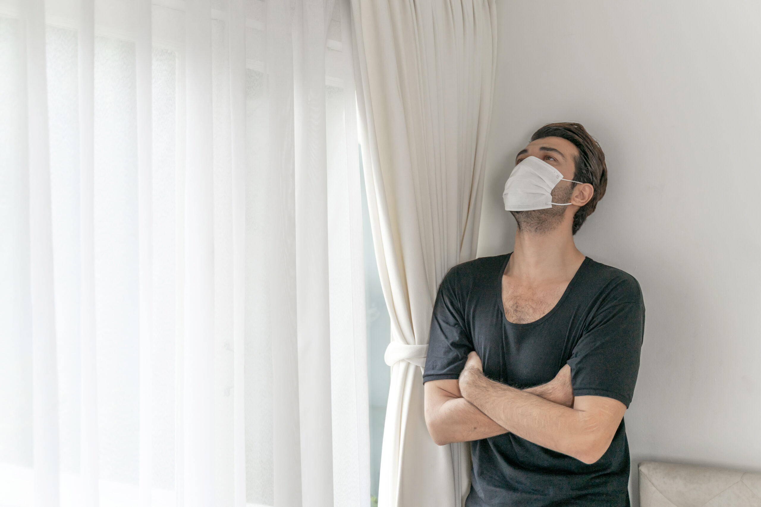 man-wearing-face-mask-protect-feeling-sick-headache-cough-because-coronavirus-covid-19-quarantine-room Man wearing a face mask to protect himself, feeling sick with headache and cough because of coronavirus COVID-19 in a quarantine room